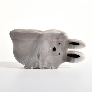 Detail of cute rabbit hair claw clip with grey marble acetate finish and wave teeth