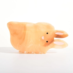 Macro detail of cute apricot acetate rabbit hair claw with marble texture and pink accents