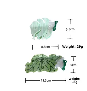 Detail view of acetate monstera leaf and lotus hair claw clips with weight and size info