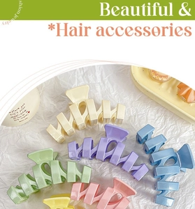 Close-up of matte glitter candy-colored large hair claws in assorted pastel shades