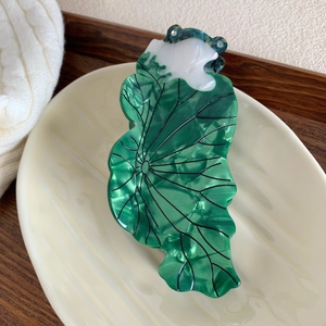 Detailed view of lotus leaf hair claw clip with green marble texture and fine veins