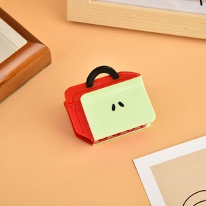 Miniature handbag-shaped acetate hair claw clip with red and green color-block design
