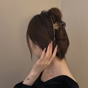 Minimalist large amber tortoiseshell hair claw clip for elegant bun hairstyles