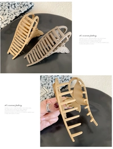 Detail showing matte butterfly hair claws in beige and taupe colors for hair styling