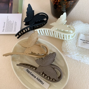 Set of four matte butterfly hair claws in black, cream, khaki, and brown resin colors