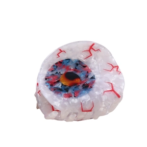 Creepy eyeball hair claw clip with red bloodshot veins and blue iris on white background