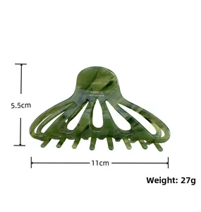 Detailed view of dark green marble hair claw clip with 11cm length and 5.5cm height