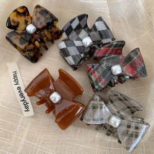 Set of five acetic acid bow hair claws with pearl embellishments in various stylish patterns