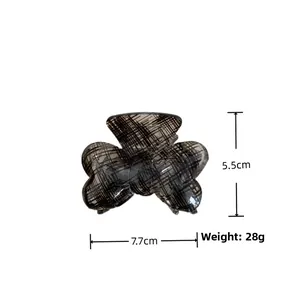 Detail view showing dimensions of checkered acrylic hair claw clip with bow design
