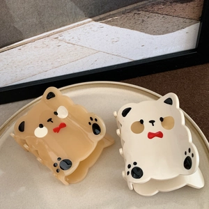 Pair of cute bear acetate hair claws in brown and cream white with red bow accents