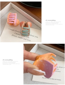 Detail of matte gradient hair claws with colorful polka dots and strong metal springs