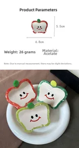 Detail view of cute apple-shaped acetate hair claw clips with size specifications