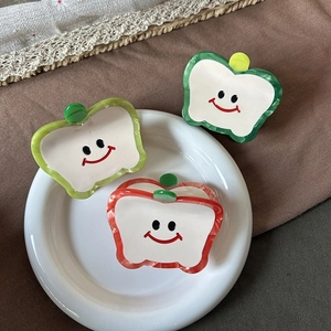 Cute apple-shaped acetate hair claw clips with smiley face patterns in three colors