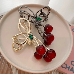 Elegant cherry-shaped metal hair claws in gold and gunblack finish with red beads
