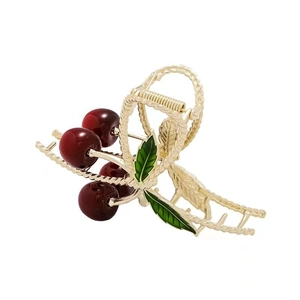 Elegant gold metal cherry claw clip with red beads and green enamel leaves for women