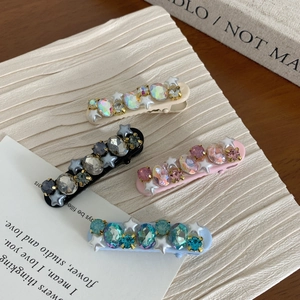 Sparkly rhinestone hair clips set with star charms in beige black pink and blue