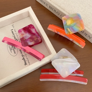 Elegant tortoiseshell acetate hair claws and rectangle clips in vibrant marble colors