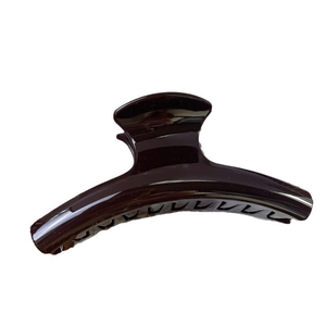 Polished dark brown resin hair claw clip with large curved handle for daily updo styling