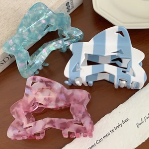 Three-piece acetate hair claw clips in star geometric shapes with marble and glitter patterns