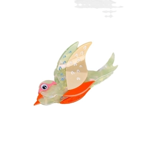 Pince à cheveux oiseau en acétate vert translucide avec des ailes orange