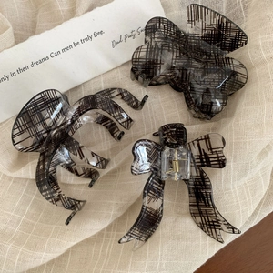 Three-piece hair claw clip set with black textured pattern in translucent smoke grey resin