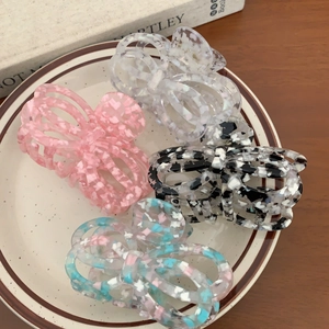 Set of four French acetate butterfly hair claws in pink, white, and floral marble patterns