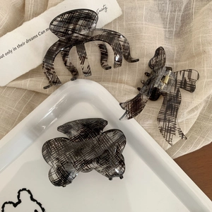 Three-piece hair claw clip set with black plaid texture on translucent resin base