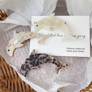 Three-piece set of elegant dolphin hair clips in marble white, beige, and leopard patterns