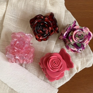 Elegant rose shaped acetate hair claws in assorted floral patterns and marble finishes