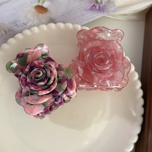 Elegant acetate rose flower hair claw clip with marble texture and golden accent label