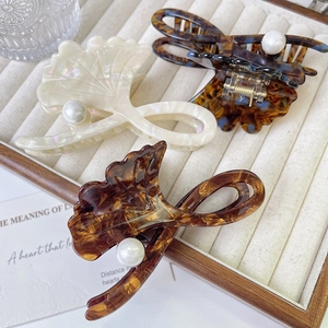 Three elegant ginkgo leaf hair claws in pearl-decorated acetate for women's hairstyles