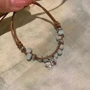 Handmade woven butterfly bracelet with ceramic beads and vintage silver charms