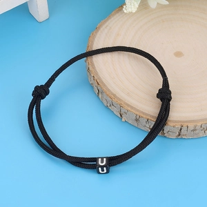 Minimalist black braided cord bracelet with square letter U charm and adjustable knots