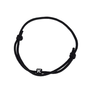 Handmade adjustable black cord bracelet featuring a square letter K charm in close-up detail