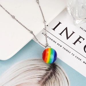 Detailed macro view of vibrant rainbow striped sphere pendant with silver bead chain