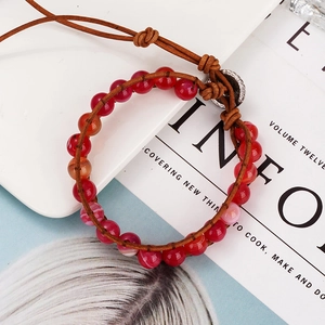 Handmade leather wrap bracelet featuring striped agate stones with adjustable cord