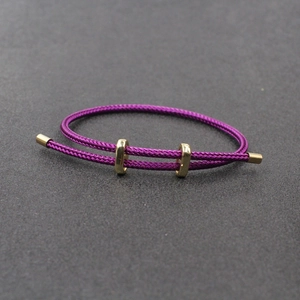 Détail du bracelet tressé violet avec fermoirs réglables en métal doré de haute qualité