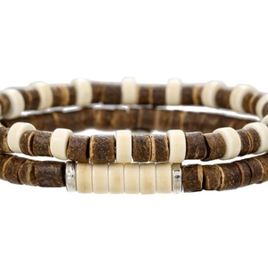 Macro detail of coconut shell and bone beads stacked bracelets with silver spacers