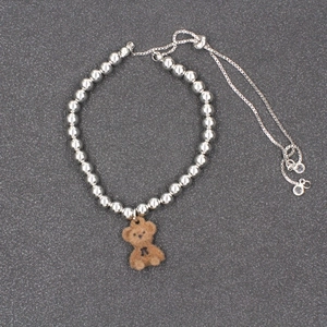 Fashionable silver beaded bracelet with brown flocked teddy bear pendant and zircon details