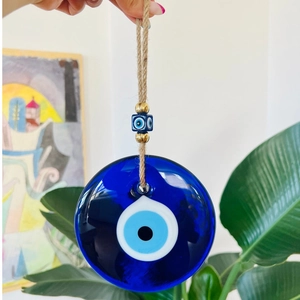 Blue glass evil eye wall hanging decor with golden beads and rustic jute rope tassel