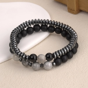 Mens beaded bracelet set with matte black stones and gray marble beads on beige background