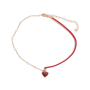 Elegant pearl and red velvet choker necklace with a gold chain and heart pendant
