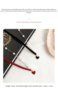 Detail view of pearl velvet chokers with heart pendants in black and dark red colors