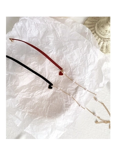 Detail of red and black fabric heart chokers with gold chains and white pearls