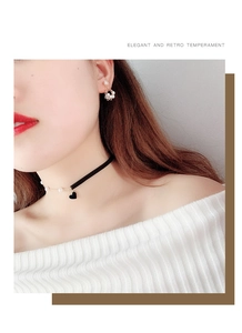 Elegant retro velvet choker set with black heart pendant and pearl earrings on a model