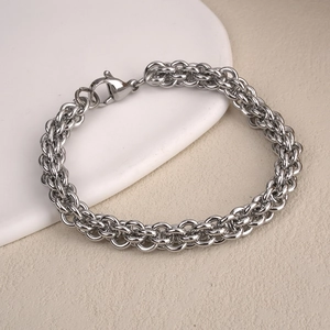 Close-up of titanium steel woven chain link bracelet with classic lobster clasp closure