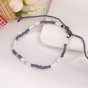 Close-up of handmade bohemian beaded bracelet with colorful beads and gray adjustable cord
