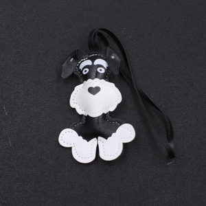 Detail of handmade leather Schnauzer dog charm with white stitching and black cord
