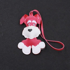 Close-up of rose red and white Schnauzer puppy leather keychain with stitching details
