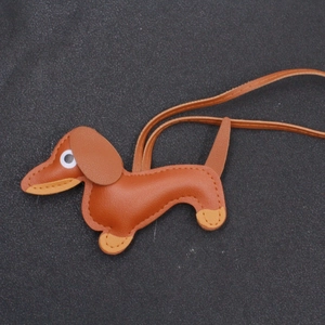 Detail of a brown leather dachshund puppy keychain with premium handmade stitching